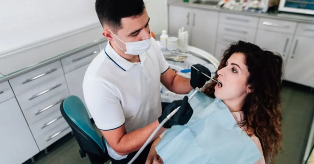 Dentist examining patient for emergency dental pain treatment