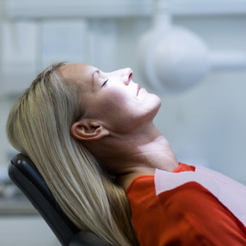 Woman relaxing on dentist chair Dunwoody Dental Health care