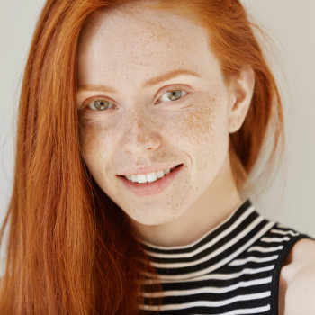 Gentle redhead girl smiling Dunwoody Dental Health patient