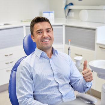 Satisfied man thumbs up in chair Dunwoody Dental Health visit